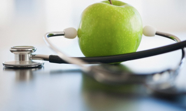 An apple attached to a stethoscope