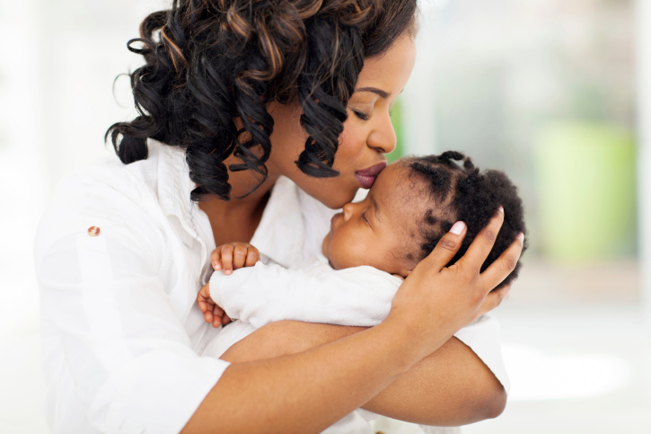 mother kissing her baby