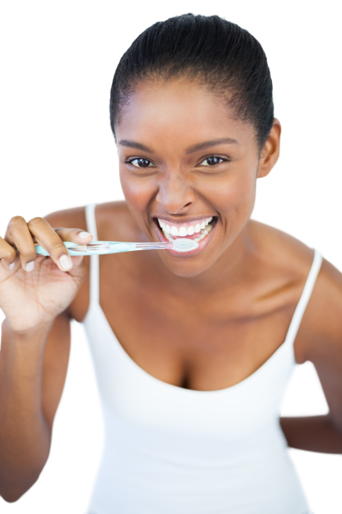 smiling woman brushing her teeth
