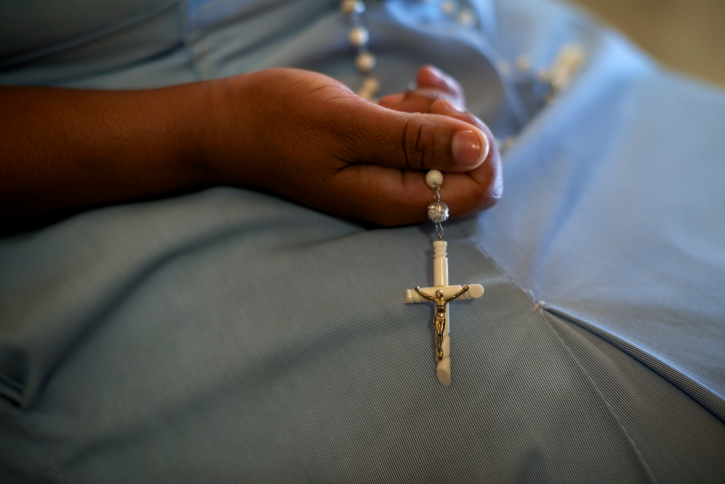 woman holding a cross in her hand 