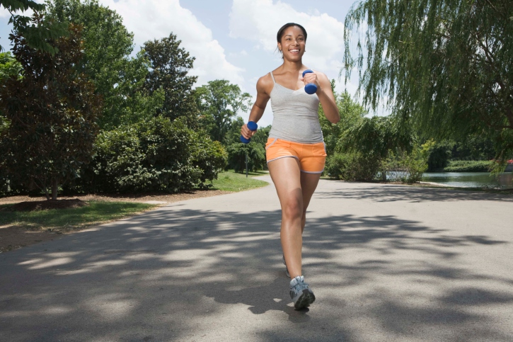 African American woman running in street sunny day