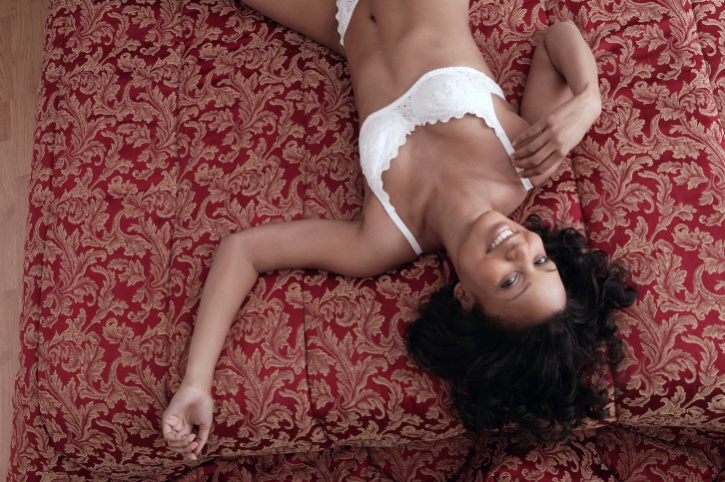 African American Black woman laying in bed underwear