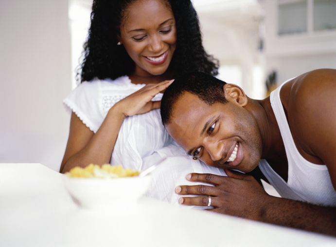 man resting his head on his wife's pregnant stomach