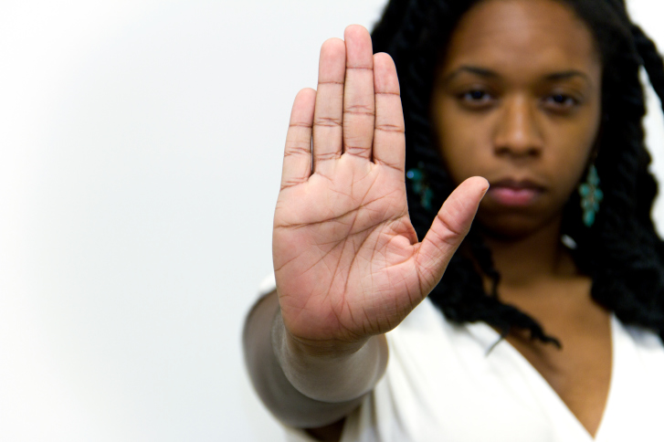 woman serious doing stop gesture