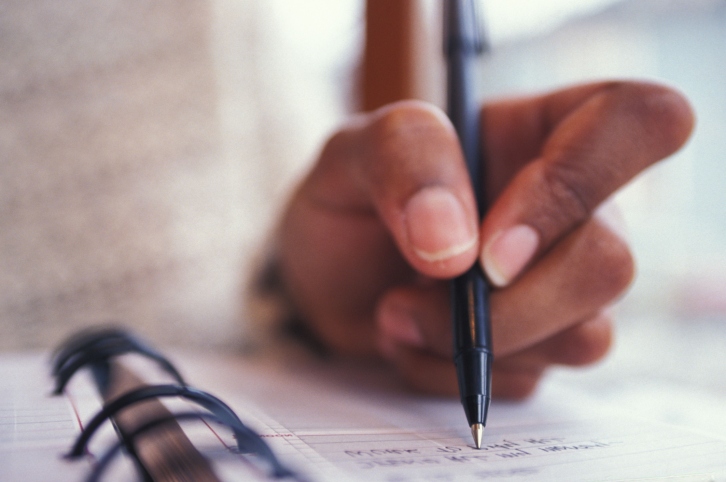 woman writing in planner