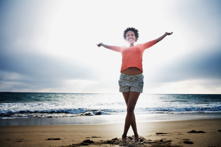 african american woman smiling on beach