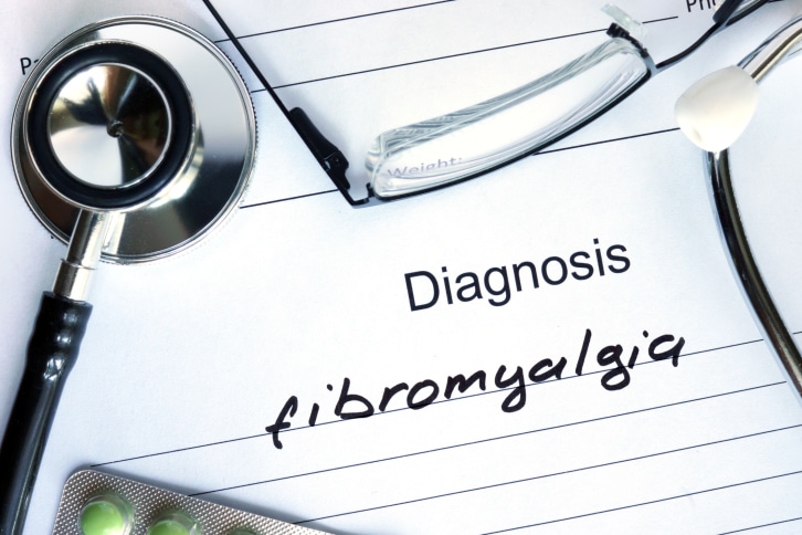 Diagnosis Fibromyalgia, pills and stethoscope.