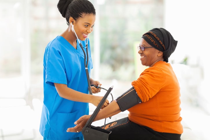 nurse taking womans blood pressure