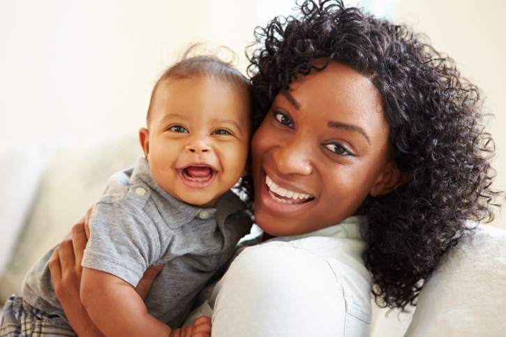 mother holding smiling baby boy