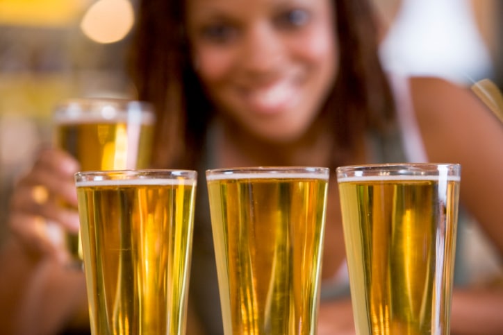 African American woman with glasses of beer