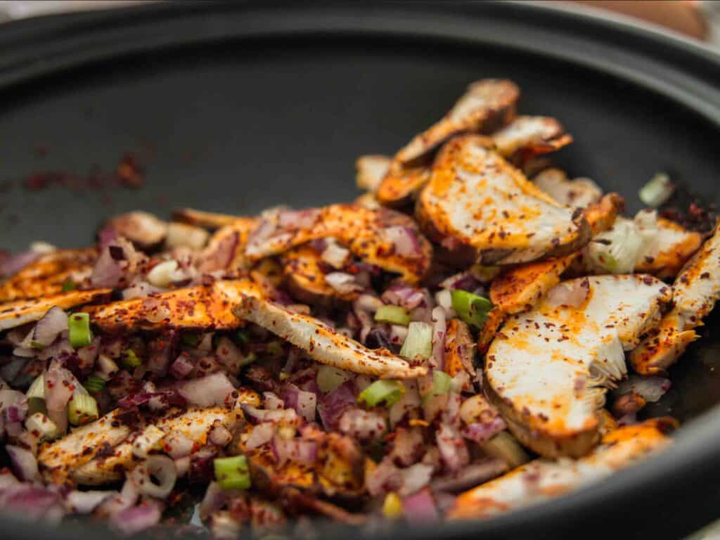 Easy & Hi-Protein Vegan Kimchi Jjigae Reigns Supreme. 11 Sauteed mushrooms, onion and garlic with gochugaru