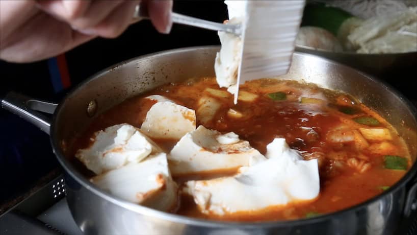 Kimchi Soondooboo Jeongol 7 Kimchi Soondooboo Jeonol, adding the tofu.