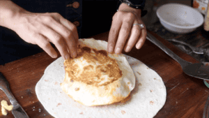 Kimchi Crunchwrap Supreme 26 Adding small tortilla to everything.