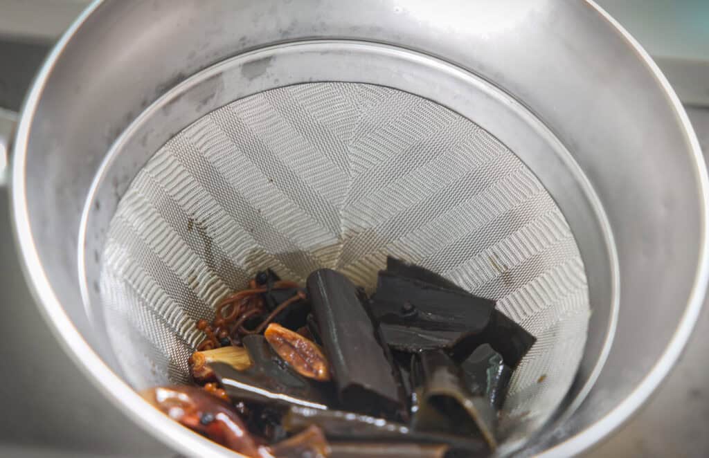 The BEST Vegan Fish Sauce (Easy & Delicious). 3 straining vegan fish sauce through chinois