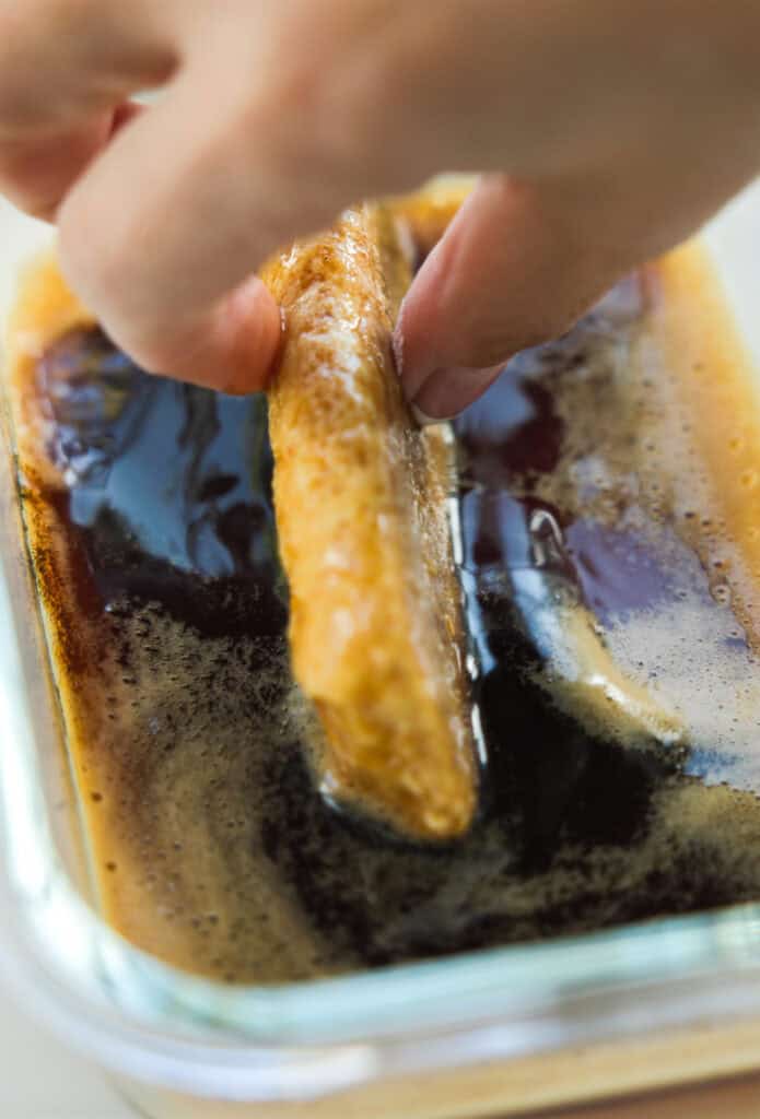 Dreamy Homemade Vegan Tiramisu Recipe (Easy & Delicious) 13 single ladyfinger soaking in espresso syrup