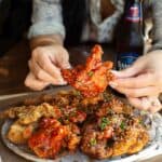 30+ AMAZING VEGAN Holiday Recipes Everyone's gonna Love. 22 holding-vegan-fried-chicken-with-spicy-sauce