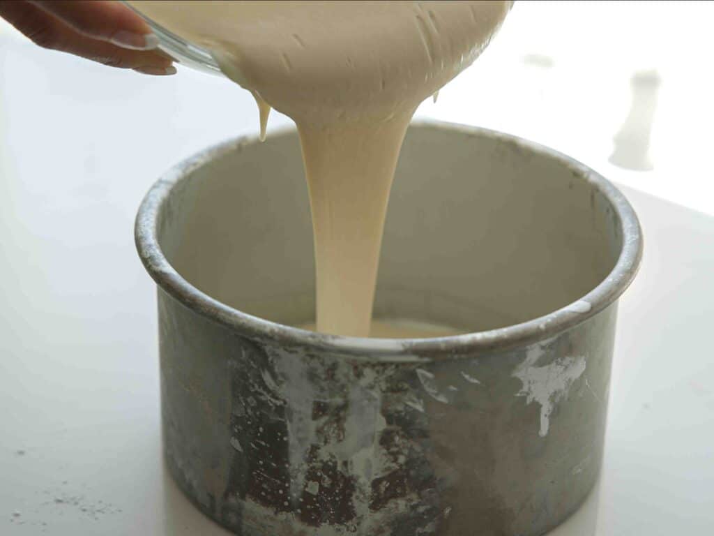 The Perfect NO BAKE Easy Vegan Sponge Cake Recipe. 12 pouring cake batter into cake pan