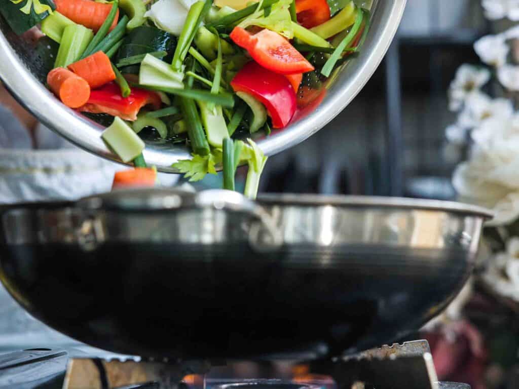 Homemade Vegan Dumplings Recipe - Kimchi Mandu. 9 adding-veggies-to-pan-for-vegan-dumpings-recipe