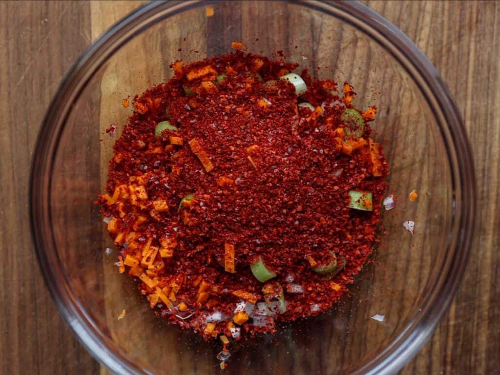 15-Minute Spicy & Cold Bibim Kimchi Noodles Recipe. 10 bowl-of-diced-carrot-green-onion-and-red-onion-and-gochugaru