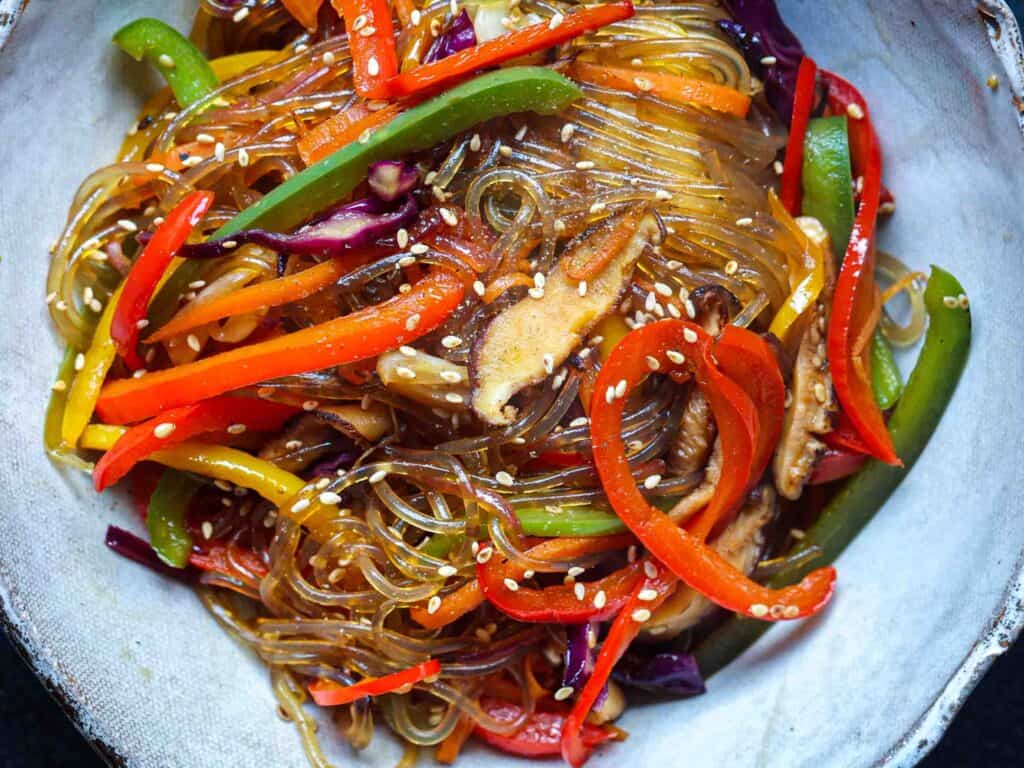 Healthy And Easy Vegan Japchae (Korean Glass Noodles). 2 finished vegan japchae in bowl