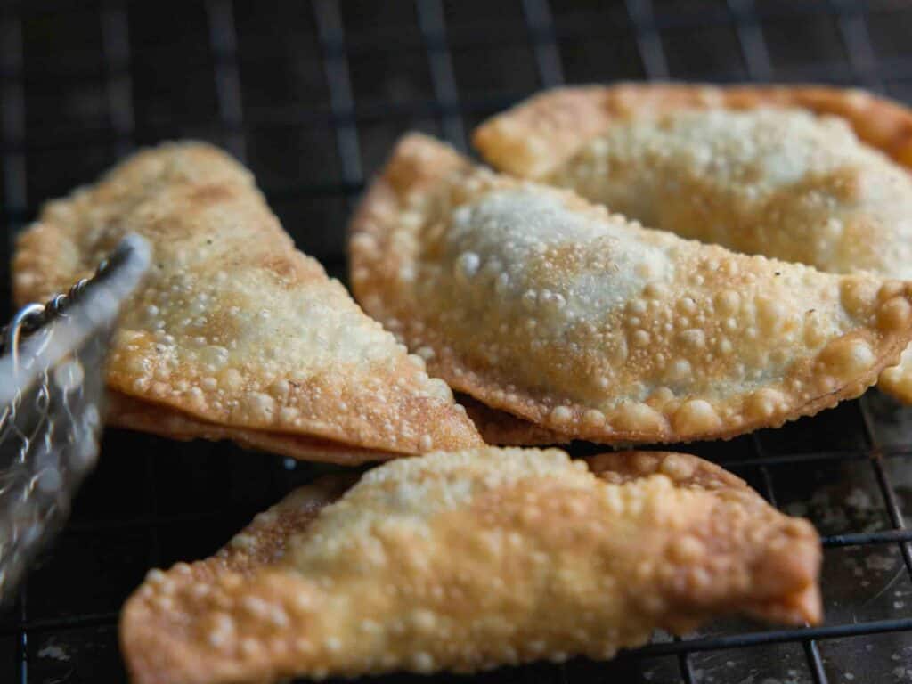 Homemade Vegan Dumplings Recipe - Kimchi Mandu. 34 placing-deep-fried-dumplings-on-wire-rack