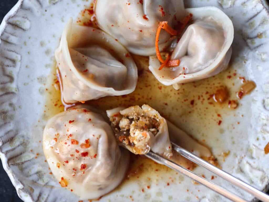 Homemade Vegan Dumplings Recipe - Kimchi Mandu. 41 plate-of-finished-boiled-dumplings-showing-insides