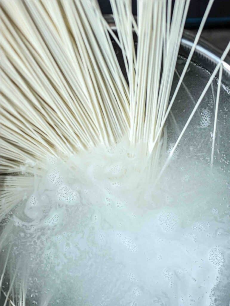15-Minute Spicy & Cold Bibim Kimchi Noodles Recipe. 4 raw-somyeon-dropped-in-boiling-water-scaled