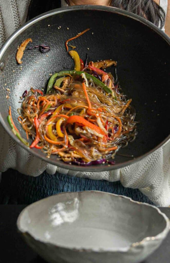Healthy And Easy Vegan Japchae (Korean Glass Noodles). 8 vegan japchae still in pan about to be poured into bowl
