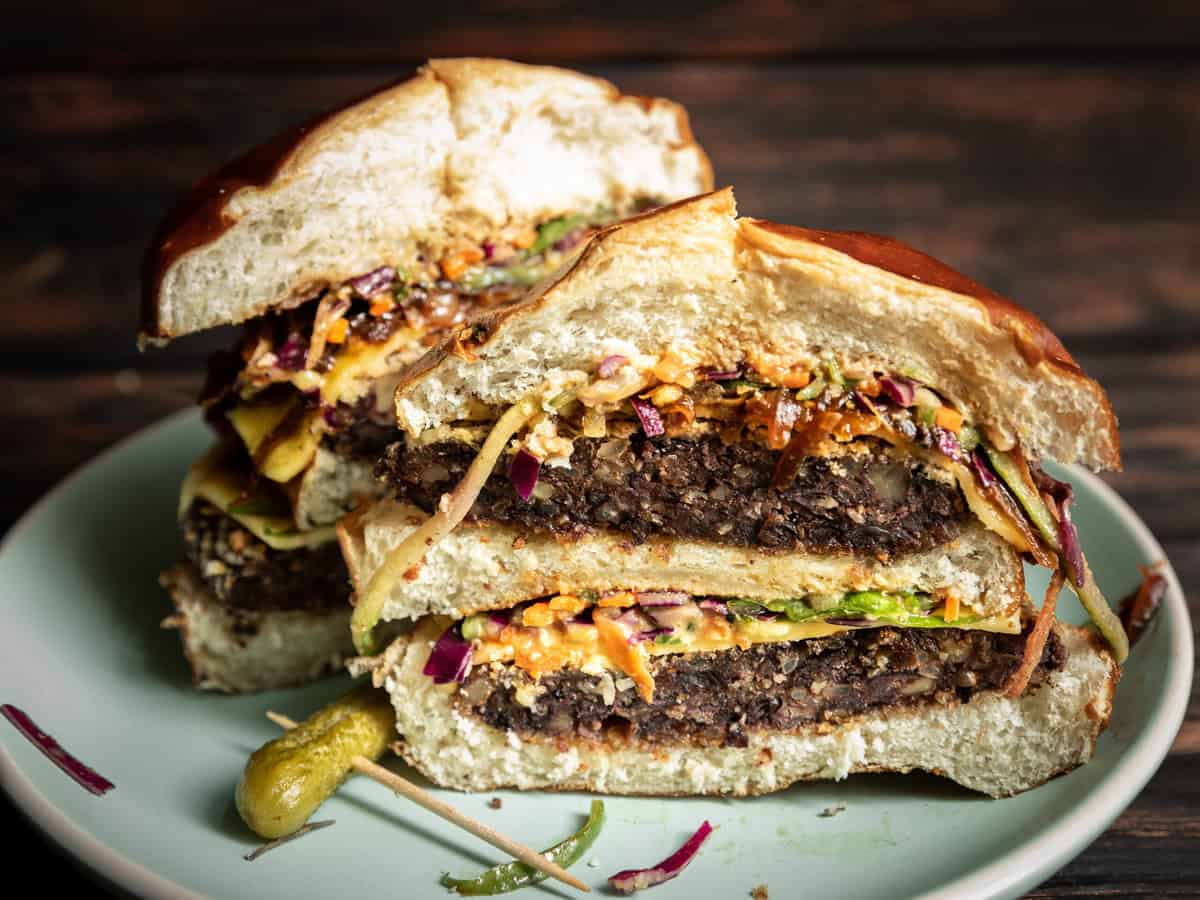Best EVER Black Bean Burger with Slaw. 2 sliced up black bean burger