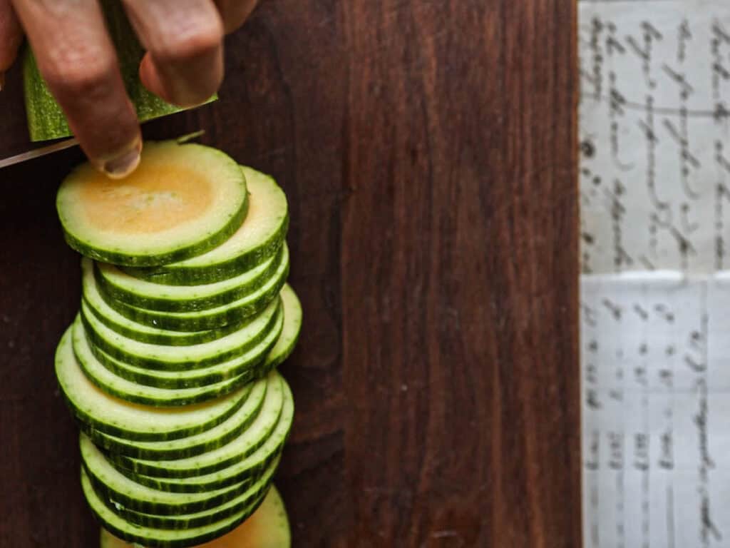 30-Minute Easy Cream Cheese Zucchini Tart (Vegan). 7 close-up-shot-of-slicing-zucchini-into-rounds