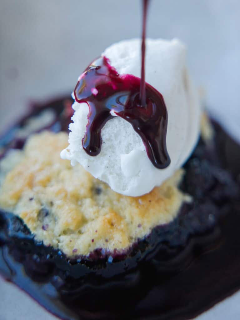 Easy Vegan Blueberry Cobbler (Gluten-Free Option!) 22 drizzling-blueberry-syrup-on-top-of-ice-cream-on-vegan-blueberry-cobbler.