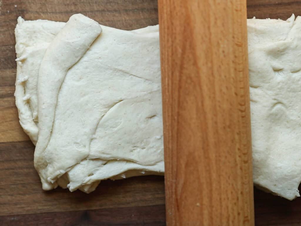 6-Ingredient Easy Cream Cheese Peach Galette Recipe. 12 flattening-stack-of-crescent-roll-dough-with-rolling-pin