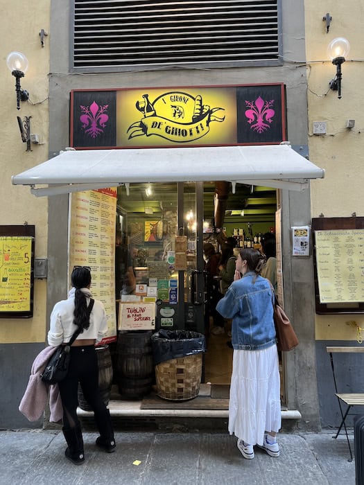 Traveling as a Vegan in Italy: An Easy & Delicious Guide. 23 Joanne checking out the menu at I' Girone De' Ghiotti