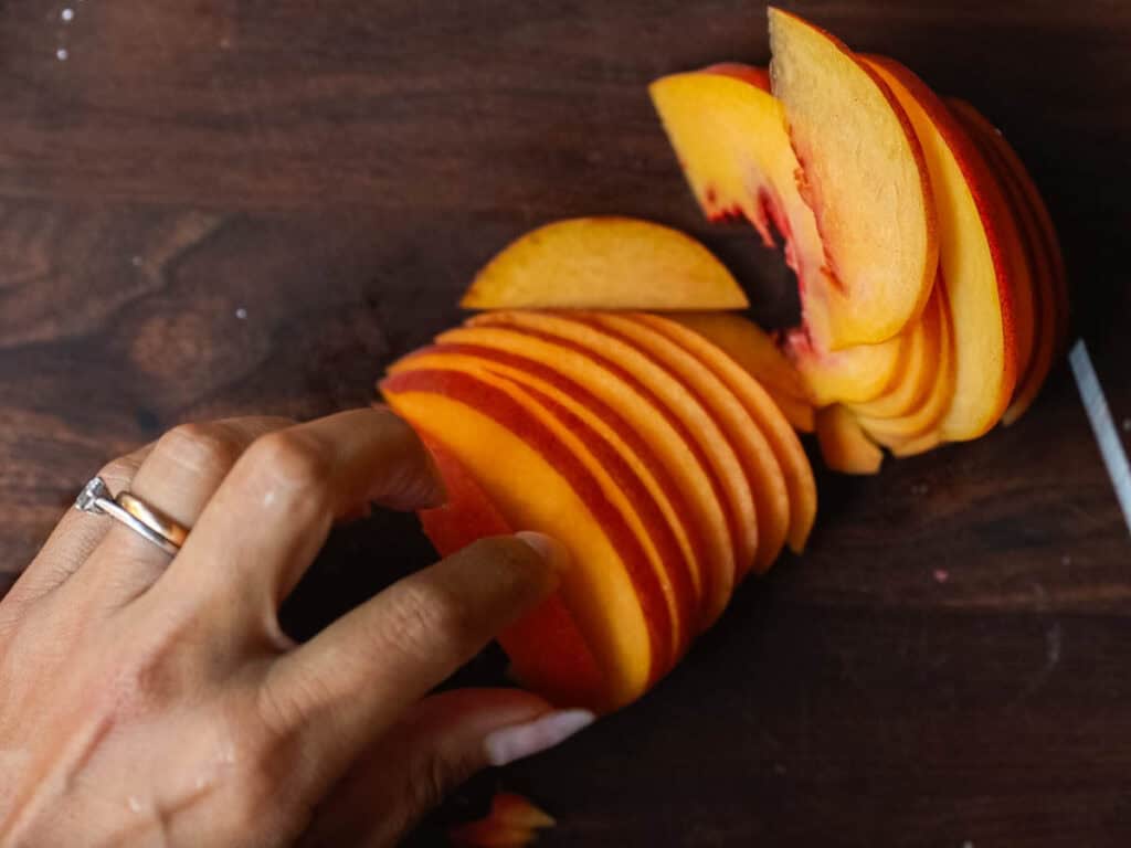 6-Ingredient Easy Cream Cheese Peach Galette Recipe. 7 cutting-peaches-into-slices