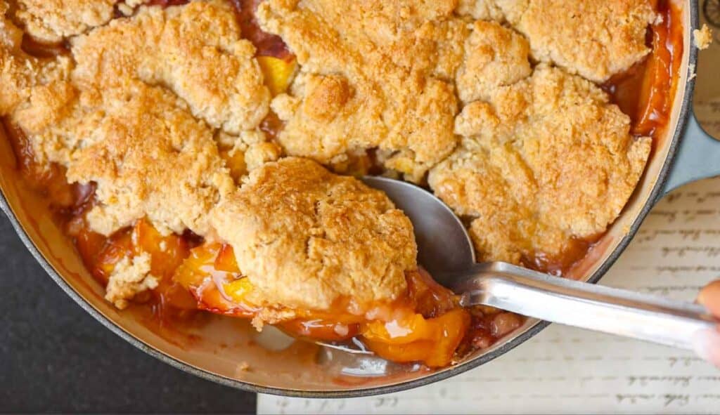 6-Ingredient Easy Cream Cheese Peach Galette Recipe. 23 hero-shot-of-scooping-out-vegan peach-cobbler
