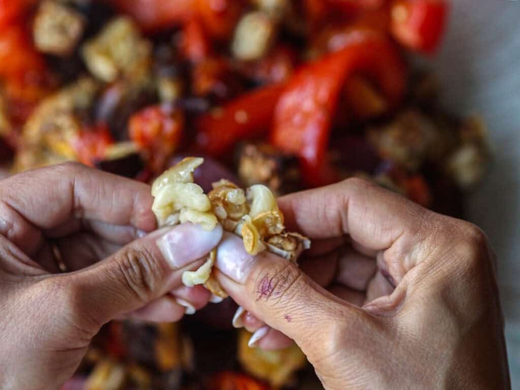 DELICIOUS Hi-Protein Vegan Mediterranean Toast Recipe. 9 squeezing-roasted-garlic-out