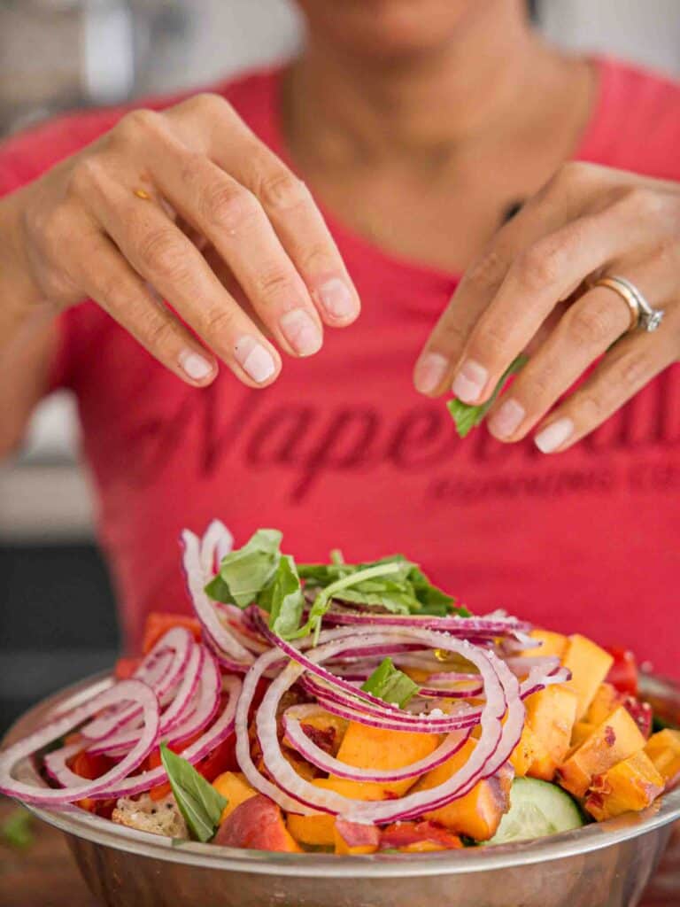 10-Minute Easy Bread Salad Recipe - Peach Panzanella. 18 adding-basil-to-bread-salad