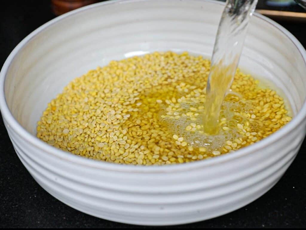 Stunning Vegan Bindaetteok: Korean Mung Bean Pancakes. 4 adding-water-to-bowl-of-dried-split-yellow-mung-beans