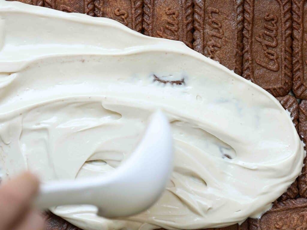 Super Easy and DELICIOUS Vegan Biscoff-Misu Recipe. 18 spreading-mascarpone-and-biscoff-buttercream-over-first-layer-of-cookies