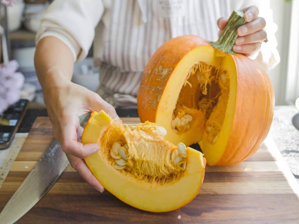 Hi-Protein Delicious Vegan Pumpkin Curry with Tofu. 5 carving up whole pumpkin