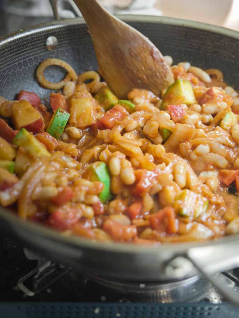 Hi-Protein Delicious Vegan Pumpkin Curry with Tofu. 22 pan of veggies and bean for pumpkin curry
