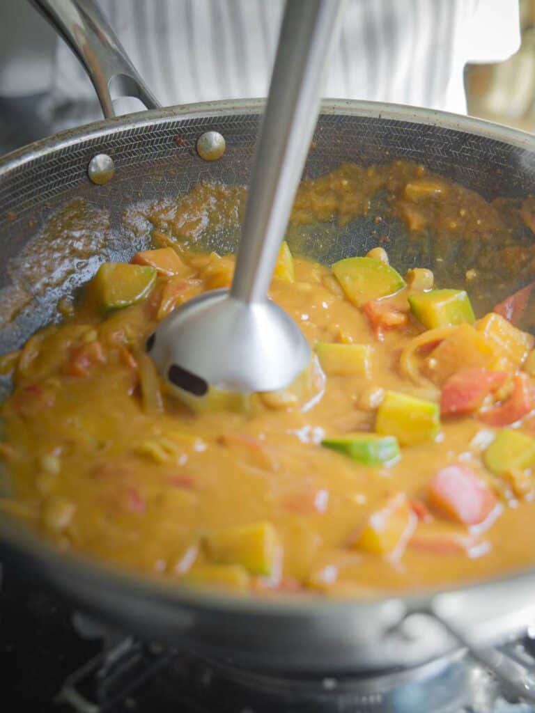 Hi-Protein Delicious Vegan Pumpkin Curry with Tofu. 25 blending curry with immersion blender