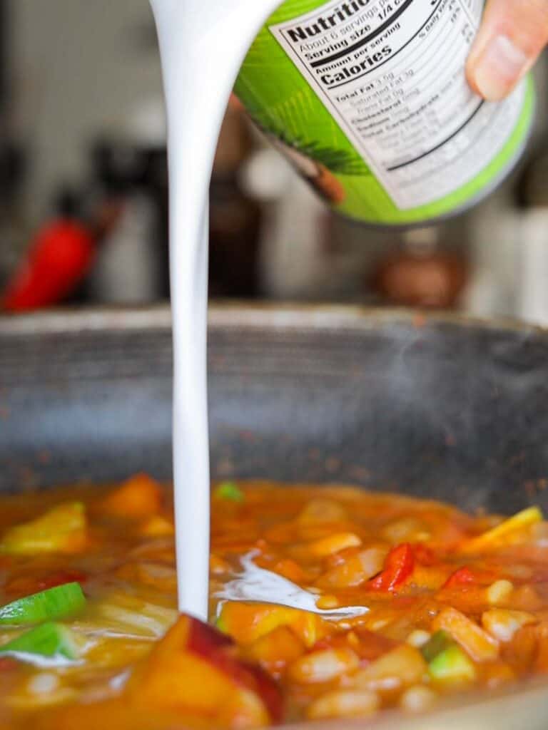 Hi-Protein Delicious Vegan Pumpkin Curry with Tofu. 13 adding coconut milk to curry sauce