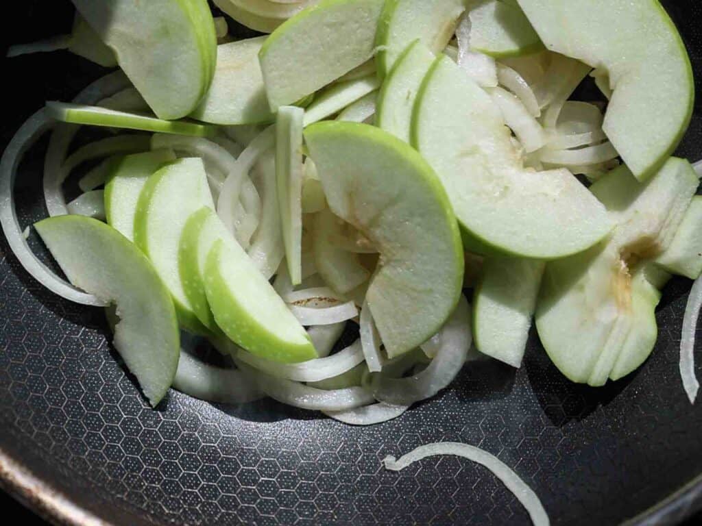 The BEST Apple Cheddar Vegan Grilled Cheese Sandwich. 11 apples and onions in pan