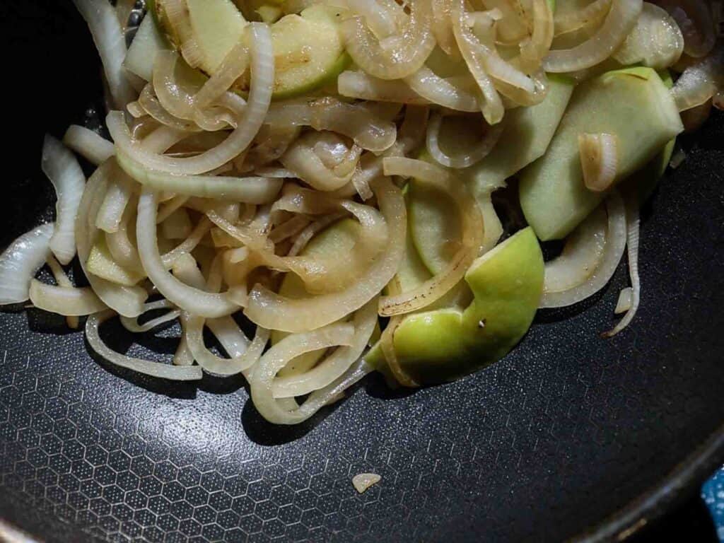 The BEST Apple Cheddar Vegan Grilled Cheese Sandwich. 12 onions and apples in pan just starting to get some color