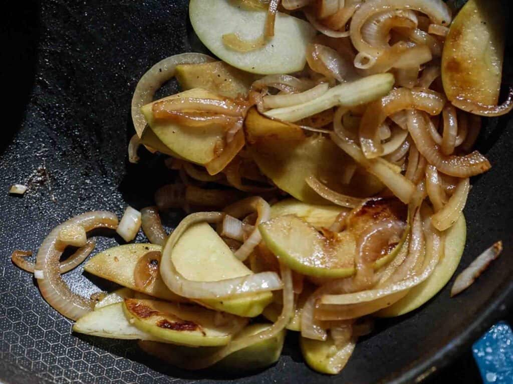 The BEST Apple Cheddar Vegan Grilled Cheese Sandwich. 13 onions and apples starting to brown in pan