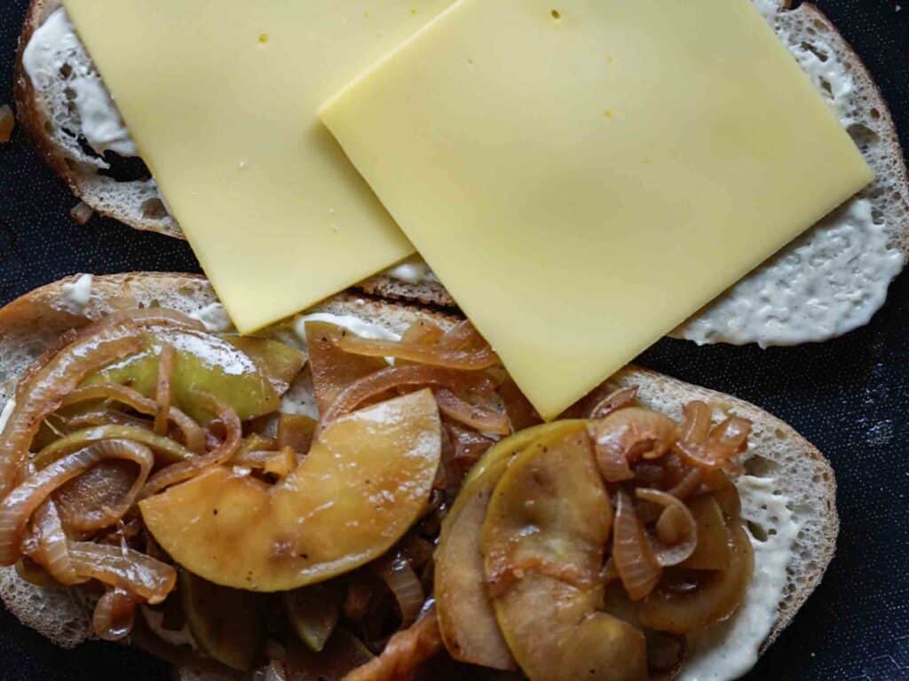 The BEST Apple Cheddar Vegan Grilled Cheese Sandwich. 21 adding provolone cheese slices to bread on pan
