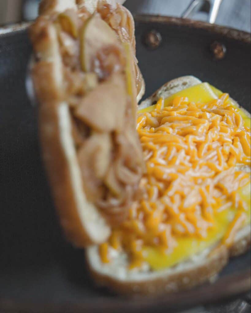 The BEST Apple Cheddar Vegan Grilled Cheese Sandwich. 25 flipping top of sandwich onto melted cheddar cheese