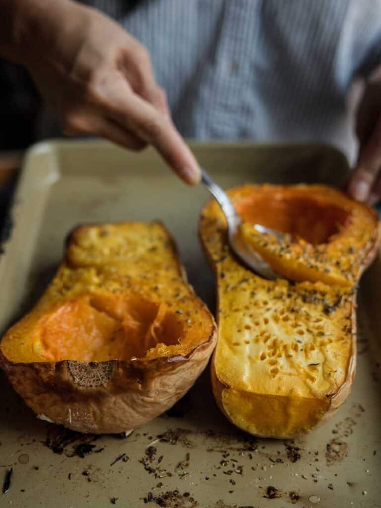 Easy and Healthy Miso & Butternut Squash Soup Recipe. 18 scooping out cooked flesh of butternut