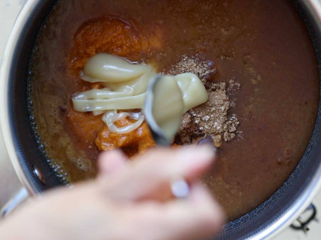 Easy Vegan Pumpkin Spice Syrup (Starbucks Copycat!). 10 adding sweetened condensed oat milk into pot